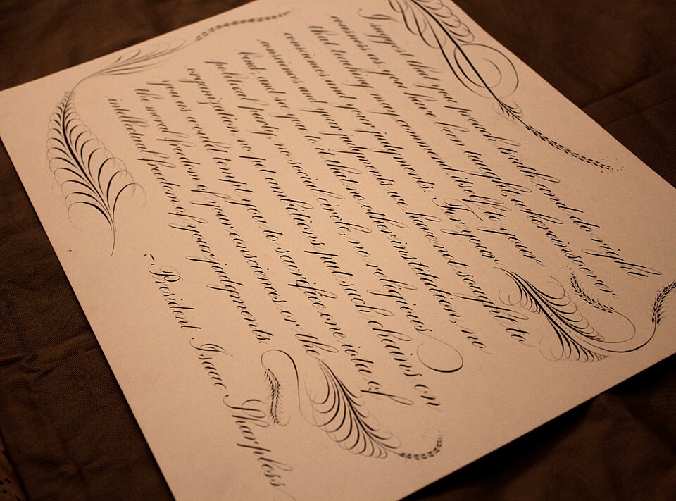 A quote written in Copperplate script with offhand flourishing.