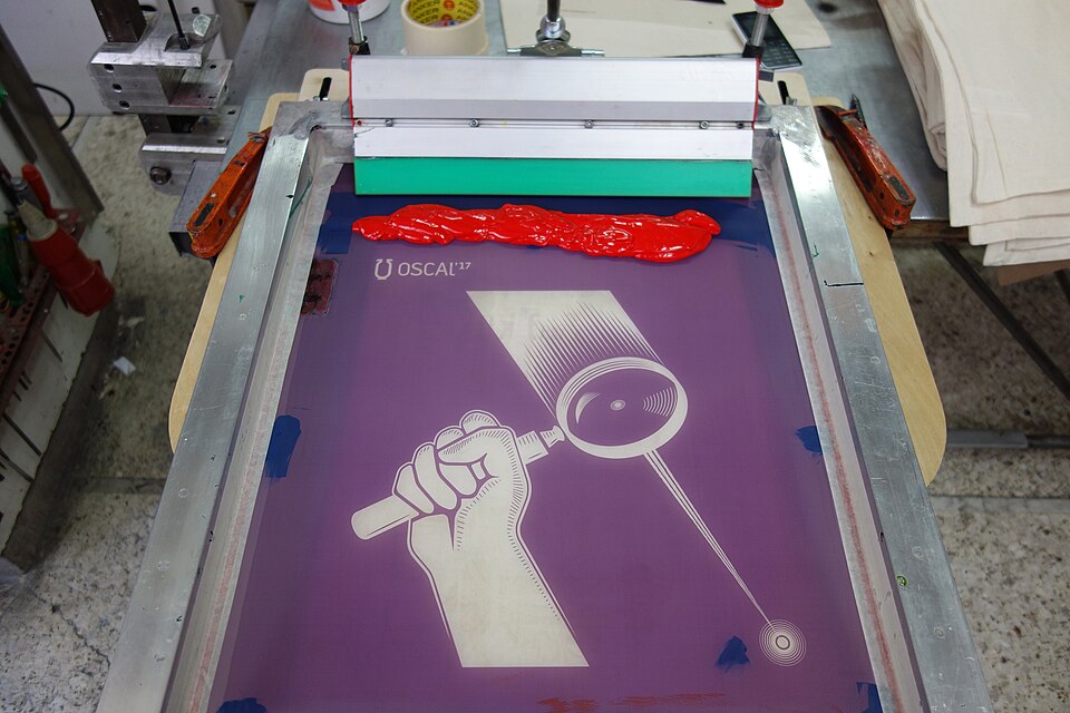 Photos from the production process of the promo materials (posters and tote bags) of the fourth edition of Open Source Conference Albania that takes place in Tirana Albania in the second weekend of May 2017. The materials were printed using the silkscreen method.