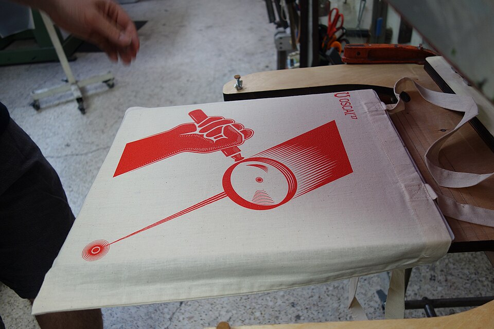 Photos from the production process of the promo materials (posters and tote bags) of the fourth edition of Open Source Conference Albania that takes place in Tirana Albania in the second weekend of May 2017. The materials were printed using the silkscreen method.
